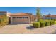 Tan house with a two-car garage and well-manicured hedges at 6425 N 79Th St, Scottsdale, AZ 85250