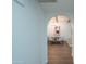 View through arched hallway shows dining area with wood floors at 6425 N 79Th St, Scottsdale, AZ 85250