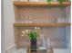 Stylish wet bar featuring a unique backsplash and shelving at 6425 N 79Th St, Scottsdale, AZ 85250