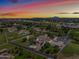 Aerial view of house, expansive backyard, and surrounding landscape at sunset at 715 S Cactus Wren St, Gilbert, AZ 85296