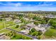 Aerial view of a luxurious home with a large backyard, pool, and expansive green lawn at 715 S Cactus Wren St, Gilbert, AZ 85296