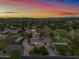 Aerial view of house, expansive backyard, and surrounding landscape at sunset at 715 S Cactus Wren St, Gilbert, AZ 85296