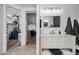 Bright bathroom features a white vanity with a marble countertop at 715 S Cactus Wren St, Gilbert, AZ 85296