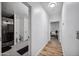 Long bathroom hallway with light walls and wood floors at 715 S Cactus Wren St, Gilbert, AZ 85296