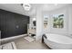 Elegant bathroom with a soaking tub and dark-gray feature wall at 715 S Cactus Wren St, Gilbert, AZ 85296