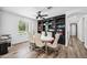 Dining area with built-in shelving, round table, and white chairs at 715 S Cactus Wren St, Gilbert, AZ 85296