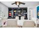 Dining area with built-in shelving, round table, and white chairs at 715 S Cactus Wren St, Gilbert, AZ 85296