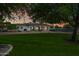 House exterior at dusk showcasing landscaping and a large front yard at 715 S Cactus Wren St, Gilbert, AZ 85296