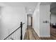 Light and bright hallway with wood flooring and a modern staircase at 715 S Cactus Wren St, Gilbert, AZ 85296