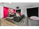 Home theater with black reclining chairs and pink wall at 715 S Cactus Wren St, Gilbert, AZ 85296