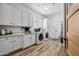 Bright laundry room with white cabinets and washer/dryer at 715 S Cactus Wren St, Gilbert, AZ 85296