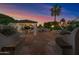 Covered patio features an outdoor kitchen, fireplace, and seating area, perfect for entertaining at 715 S Cactus Wren St, Gilbert, AZ 85296