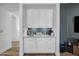 Built-in wet bar with white cabinets and a quartz countertop at 715 S Cactus Wren St, Gilbert, AZ 85296