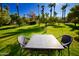 Relaxing patio area with table and chairs surrounded by lush landscaping at 7249 N Central Ave, Phoenix, AZ 85020