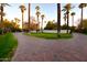 Brick driveway, lush landscaping, and palm trees leading to a stunning home at 7249 N Central Ave, Phoenix, AZ 85020