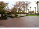 Home's entrance with brick pathway, landscaping, and a gated entry at 7249 N Central Ave, Phoenix, AZ 85020