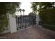 Private gated entry with brick driveway and landscaping at 7249 N Central Ave, Phoenix, AZ 85020