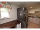 Laundry room with stacked washer and dryer, and a wood countertop at 7249 N Central Ave, Phoenix, AZ 85020