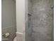 Modern shower with gray marble tile in a stylish bathroom at 7249 N Central Ave, Phoenix, AZ 85020