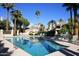 Inviting community pool with lounge chairs and palm trees at 7272 E Gainey Ranch Rd # 74, Scottsdale, AZ 85258