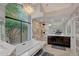 Elegant bathroom with marble finishes, a large soaking tub, and a walk-in shower at 7347 E Turquoise Ave, Scottsdale, AZ 85258