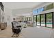 Elegant living room featuring a fireplace and pool views at 7347 E Turquoise Ave, Scottsdale, AZ 85258