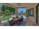 Relaxing patio with wooden table and chairs, overlooking the lush backyard and pool at 7347 E Turquoise Ave, Scottsdale, AZ 85258