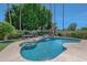 Stunning kidney shaped pool and spa surrounded by lush landscaping at 7347 E Turquoise Ave, Scottsdale, AZ 85258