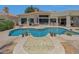 Resort-style backyard with a large pool, spa, and unique water feature at 7347 E Turquoise Ave, Scottsdale, AZ 85258