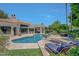 Luxury backyard oasis featuring a large pool, spa, and comfortable seating at 7347 E Turquoise Ave, Scottsdale, AZ 85258