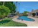 Stunning kidney-shaped pool with attached spa and lush landscaping at 7347 E Turquoise Ave, Scottsdale, AZ 85258