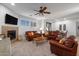 Living room with fireplace, leather furniture, and large TV at 7445 E Eagle Crest Dr # 1065, Mesa, AZ 85207