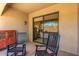 Private patio with two rocking chairs, offering views of the mountains at 7445 E Eagle Crest Dr # 1065, Mesa, AZ 85207