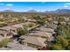 Aerial view of homes and landscape, mountains in the distance at 7691 E Fledgling Dr, Scottsdale, AZ 85255