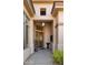 Elegant entryway with a wooden door, pendant light, and potted plants at 7691 E Fledgling Dr, Scottsdale, AZ 85255