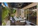 Relaxing patio with an outdoor dining area, ceiling fan, and adjacent to the house at 7691 E Fledgling Dr, Scottsdale, AZ 85255