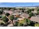 Aerial view of neighborhood homes with pools and landscaping; mountains and industrial area in the distance at 7893 S Stephanie Ln, Tempe, AZ 85284