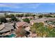 Aerial view of neighborhood homes with pools and landscaping; mountains and industrial area in the distance at 7893 S Stephanie Ln, Tempe, AZ 85284