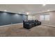 Finished basement with neutral walls and three reclining chairs at 7893 S Stephanie Ln, Tempe, AZ 85284