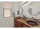 Bathroom with double sinks, stone backsplash and modern fixtures at 7893 S Stephanie Ln, Tempe, AZ 85284