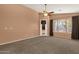 Bright bedroom with carpeted floors, ceiling fan, and sliding glass door at 7893 S Stephanie Ln, Tempe, AZ 85284