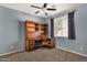 Well-lit bedroom with built-in desk and plush carpet at 7893 S Stephanie Ln, Tempe, AZ 85284