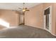 Bedroom with carpeted floors, ceiling fan, and door to hallway at 7893 S Stephanie Ln, Tempe, AZ 85284