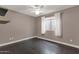 Spacious bedroom with dark hardwood floors and neutral walls at 7893 S Stephanie Ln, Tempe, AZ 85284