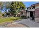 Brick home with lush landscaping and a walkway at 7893 S Stephanie Ln, Tempe, AZ 85284