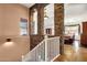 View of staircase with stone pillars and white railing overlooking dining area at 7893 S Stephanie Ln, Tempe, AZ 85284