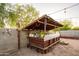 Outdoor backyard bar with wood cover, lattice, and seating at 7917 W Sierra Vista Dr, Glendale, AZ 85303