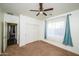 Bedroom with teal curtains and ceiling fan at 7917 W Sierra Vista Dr, Glendale, AZ 85303