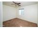 Well-lit bedroom with ceiling fan and brown carpet at 7917 W Sierra Vista Dr, Glendale, AZ 85303