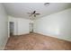 Spacious bedroom with ceiling fan and carpet at 7917 W Sierra Vista Dr, Glendale, AZ 85303